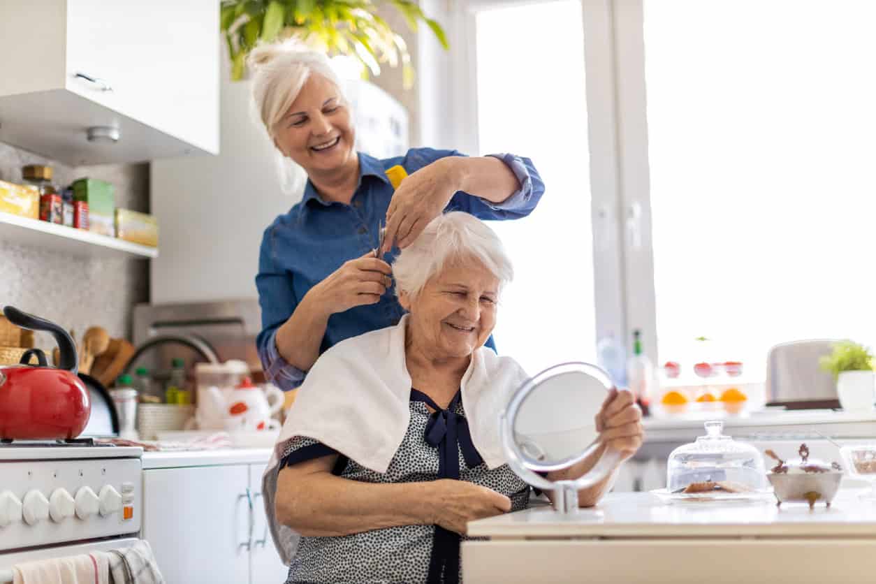 Live in carer providing personal care and cutting her clients hair.